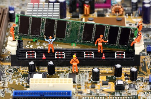 Miniature workers installing RAM memory