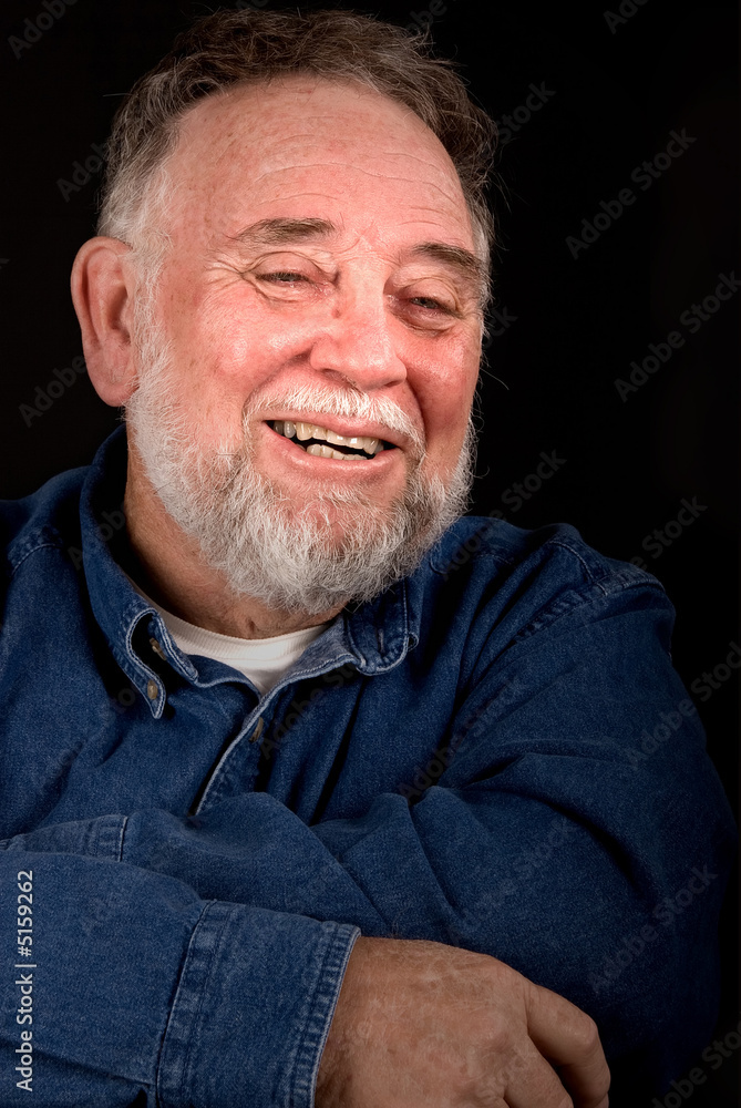 Fototapeta premium smiling old man over black