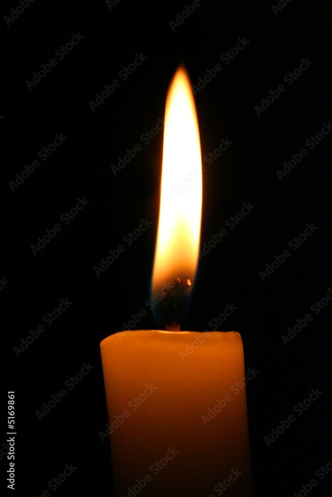 Warm light of a candle in a dark place