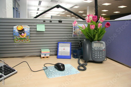 Office desk with phone and flowers