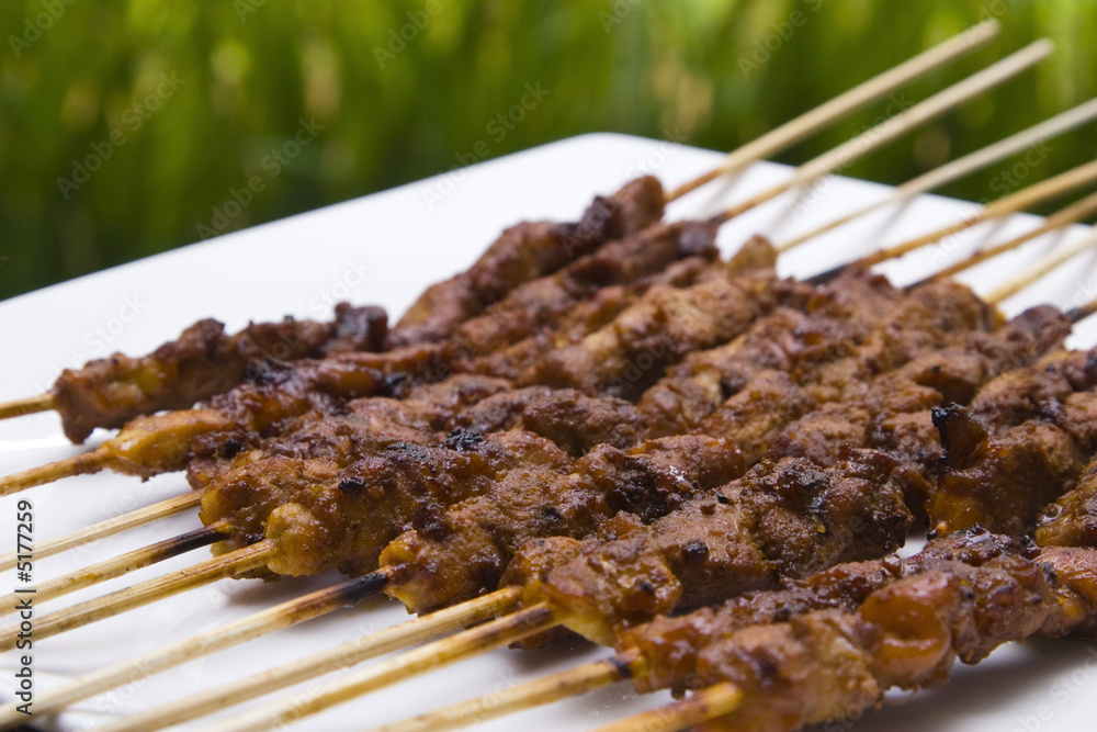 chicken satay skewer close up perspective