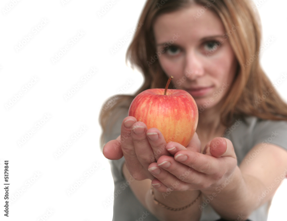 The nice girl holds a tasty apple in hands The nice girl holds a tasty apple in hands