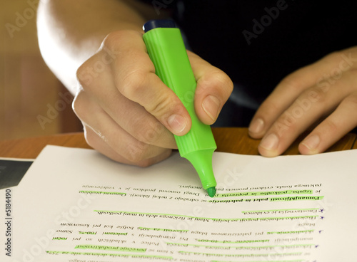 Student using marker to mark important text
