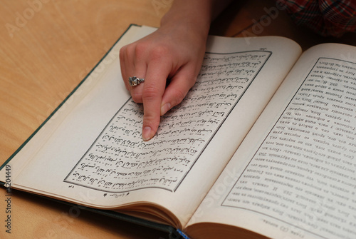 Close up of girl's finger on Quran