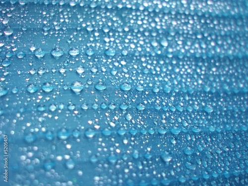 Blue water drops on wet surface