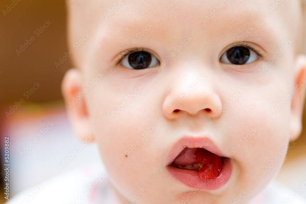 Baby eating apple. Children's face close-up Baby eating apple. Children's face close-up