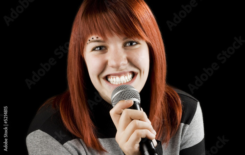Joyful girl singing on the karaoke