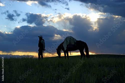 Cowboy with pack horse at dawn