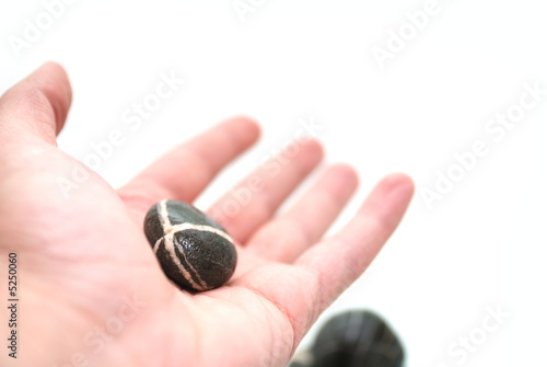 zen stone on palm
