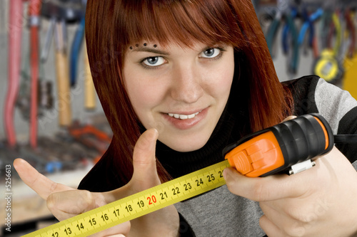 Redhead girl with measuring tool ruler