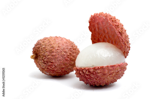 2 lychees, one is cut in half and opened