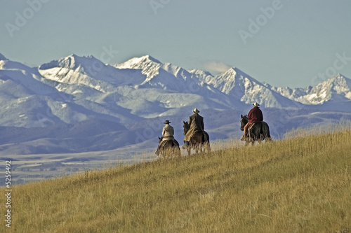 Cowboys on the range on a Montana horse ranch photo