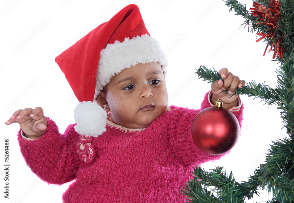 baby girl playing with christmas tree baby girl playing with christmas tree