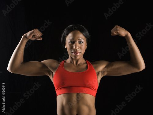Woman flexing muscles. © iofoto
