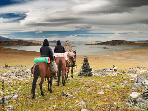 Horseriders in mongolian wildernesss