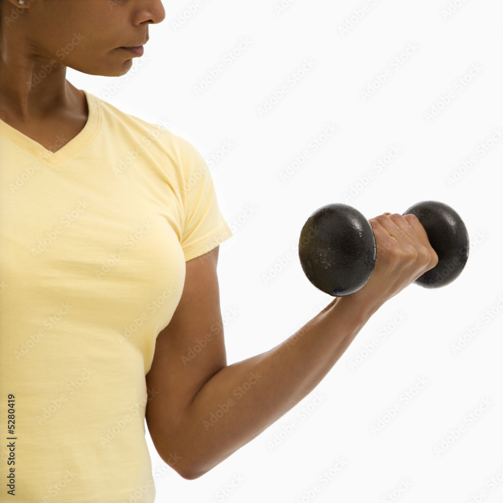 Woman exercising with dumbbell. Woman exercising with dumbbell.