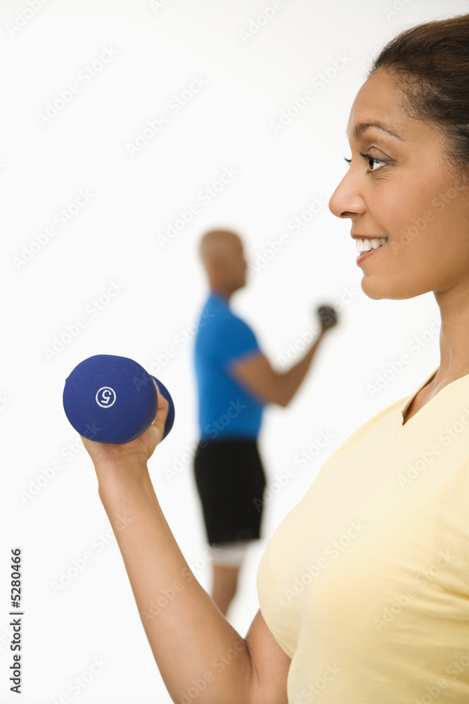 Woman exercising with dumbbell.