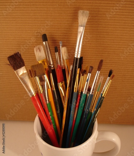Paint Brushes Rustic Background in white cup