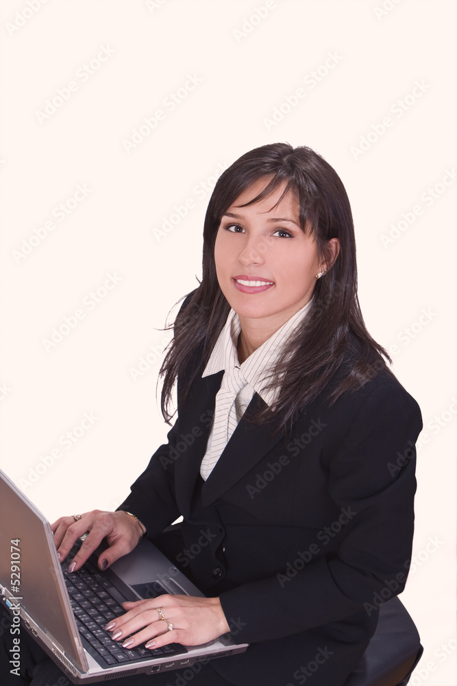 Smilling brunette working on a laptop Smilling brunette working on a laptop