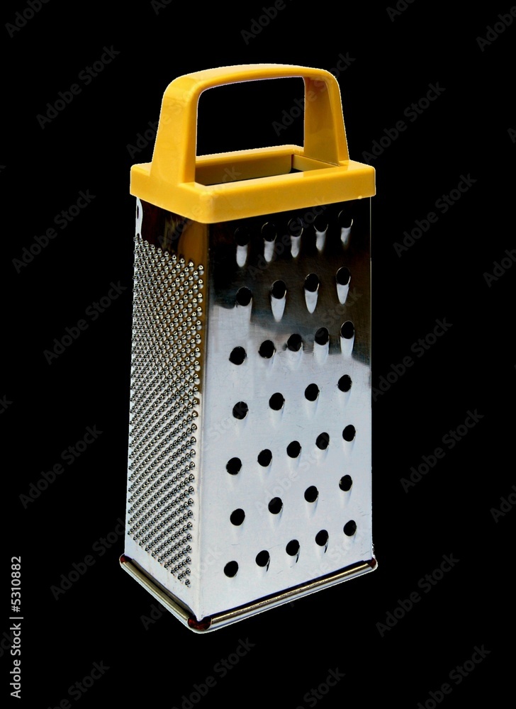 Cheese grater against a black background Cheese grater against a black background