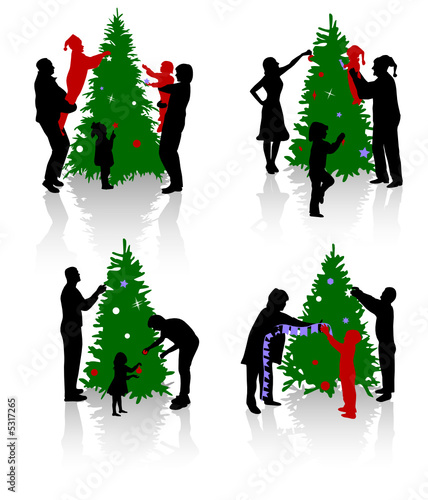 Silhouettes of the people decorating a Christmas tree.