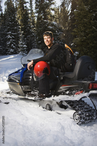 Man on snowmobile.