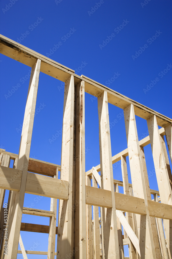Framework of new construction with blue sky in background. Framework of new construction with blue sky in background.