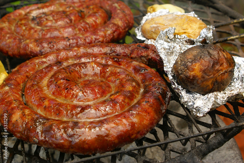 Sausages and potatoes in foil photo