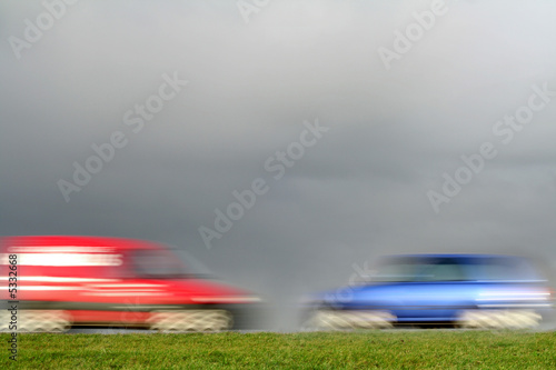 red and blue car, racing towards eachother