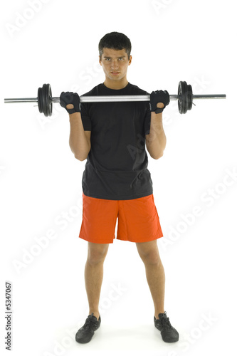 Young man exercising arms muscles with barbell