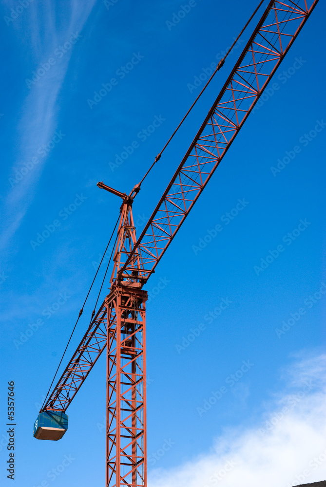 Crane for building industry and blue sky with clouds