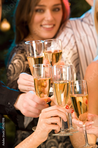 Group of champagne glasses clinking together