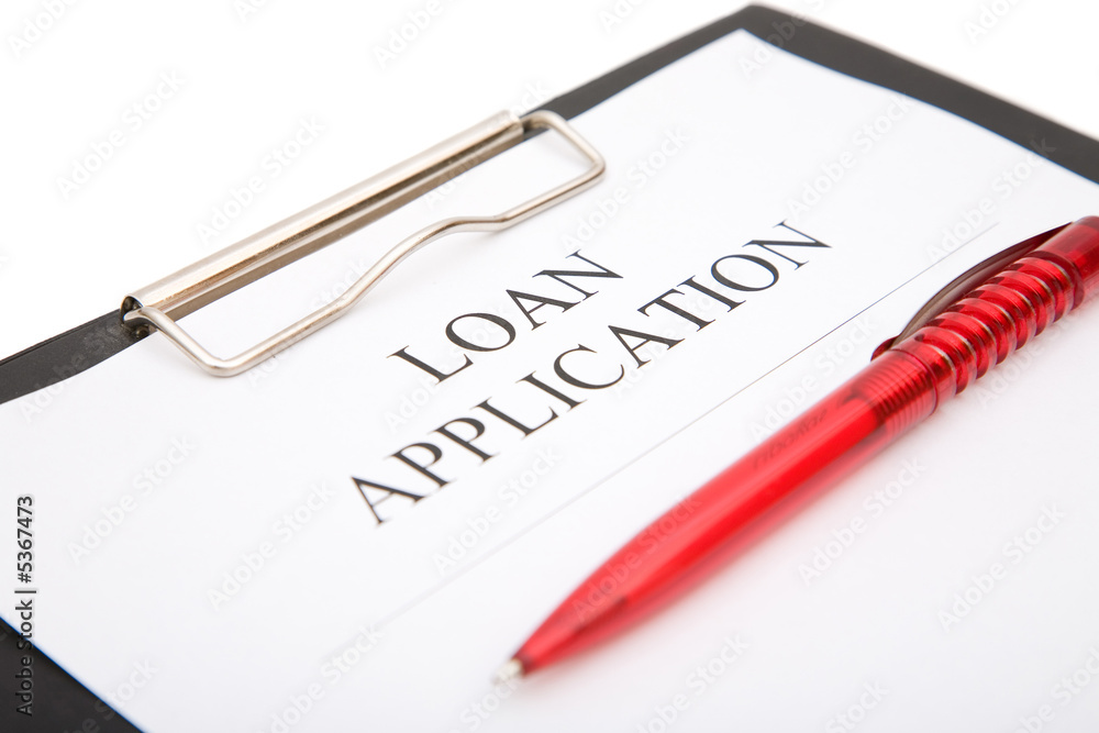 business loan application form with red pen on white background business loan application form with red pen on white background
