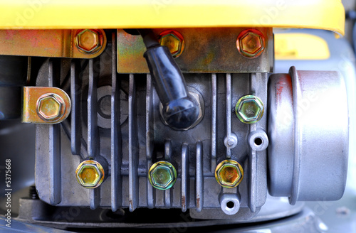 a small lawn mover engine showing spark plug and exhaust