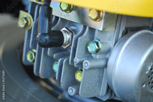 a small lawn mover engine showing spark plug and exhaust