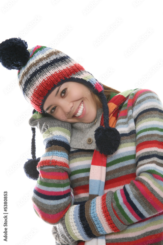 A cute girl in winter clothes over a white background