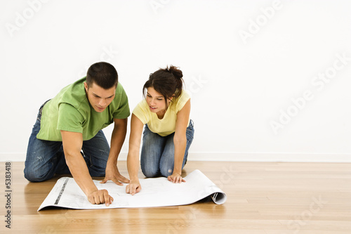 Couple with house plans.