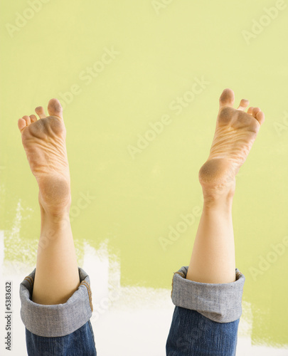 Caucasian female legs and dirty feet sticking up in air.