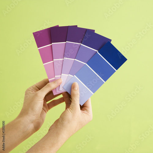 Caucasian female hands holding paint color samples. © iofoto