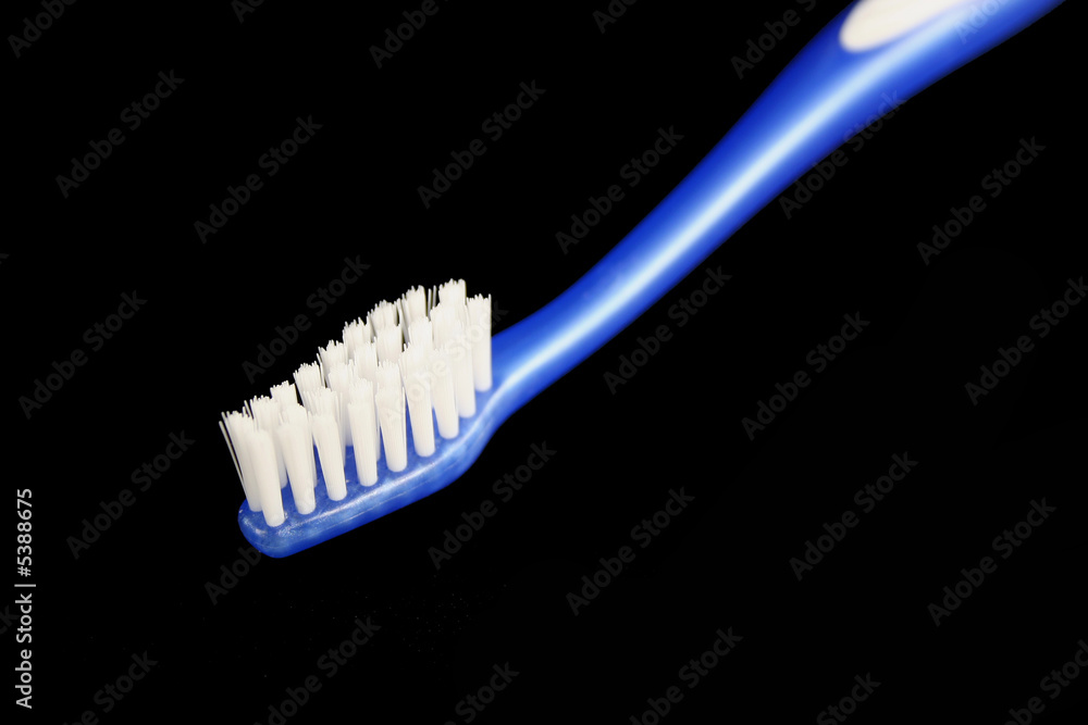 Isolated blue toothbrush on black background Isolated blue toothbrush on black background