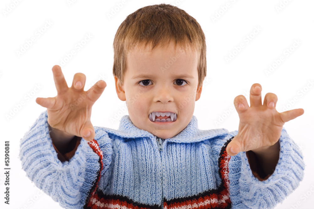 Boy playing with fake vampire teeth - childhood fun Boy playing with fake vampire teeth - childhood fun