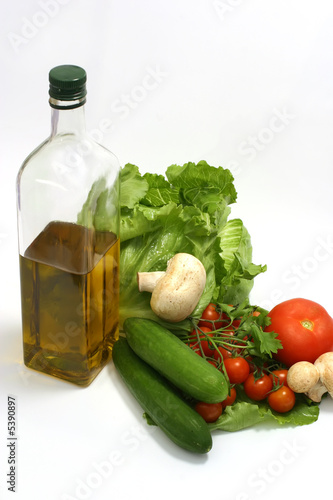 Olive oil in bottle,parsley, tomatom, mushroom,cucumber