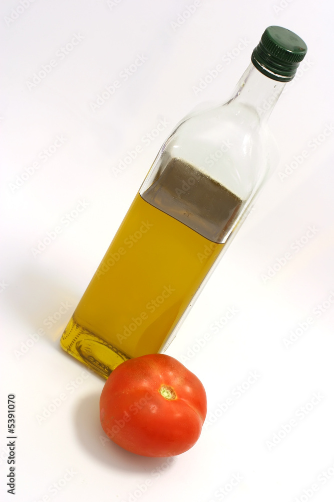 Fototapeta premium Olive oil in transparent bottle with one big tomato
