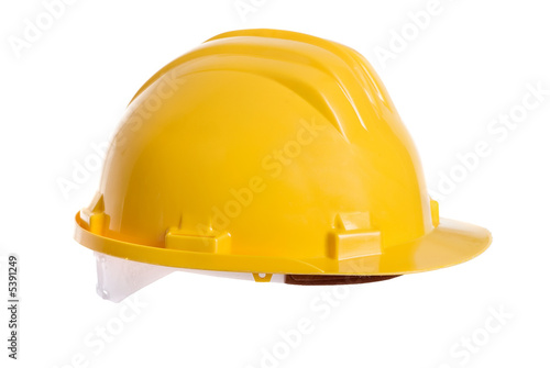 A bright yellow safety hardhat from a construction site.