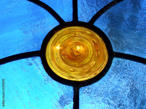 Orange circle sprouting lead channels in blue stained glass