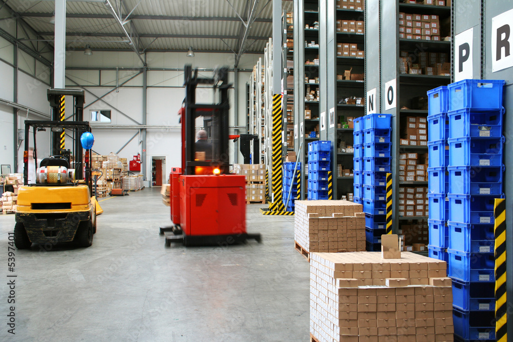 Busy warehouse with pallet trucks working