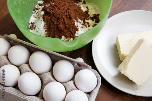 Baking ingredients on table: eggs, butter and flour