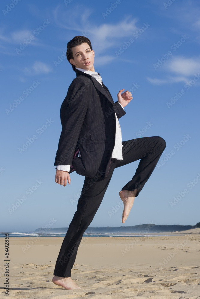 Young business man in suit on the beach Young business man in suit on the beach