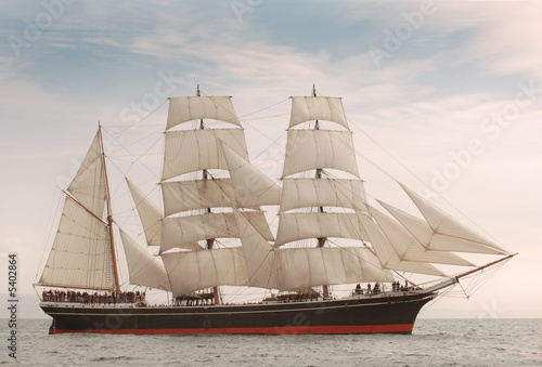 Fototapeta Vintage windjammer style ship with full sails on the open sea