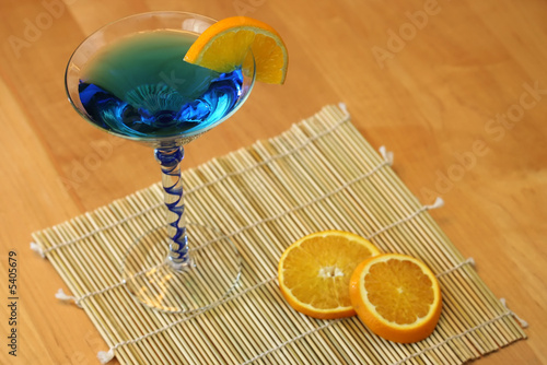 A blue martini cocktail with orange slices photo